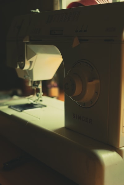 white sewing machine on white table